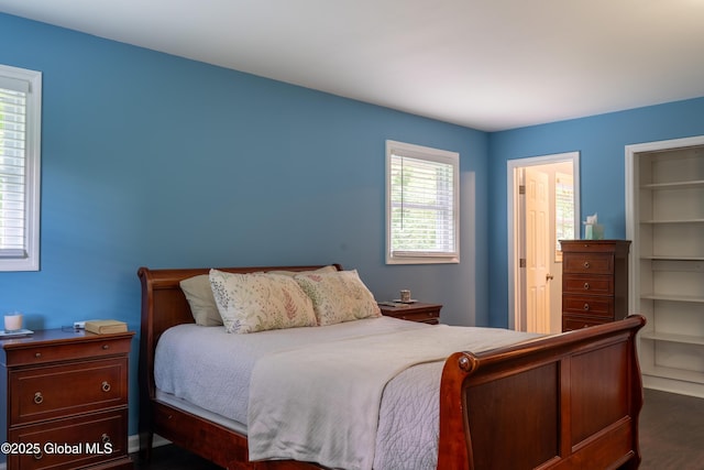 12 Heritage Ln, Clifton Park, NY 12065 - bedroom with dark wood-type flooring, a closet, and a walk in closet