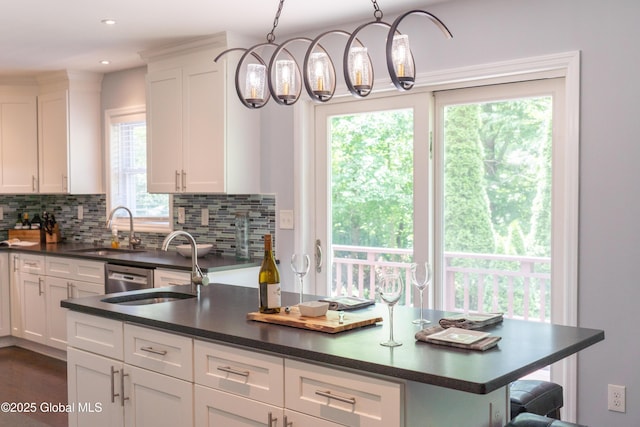 12 Heritage Ln, Clifton Park, NY 12065 - kitchen featuring dark countertops, tasteful backsplash, white cabinetry, hanging light fixtures, and recessed lighting