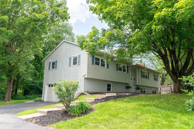 12 Heritage Ln, Clifton Park, NY 12065 - rear view of house featuring a chimney, an attached garage, and driveway
