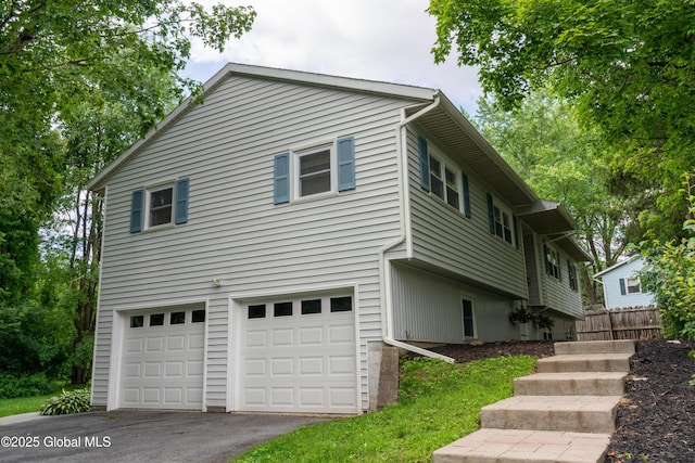 12 Heritage Ln, Clifton Park, NY 12065 - view of front facade featuring an attached garage and asphalt driveway