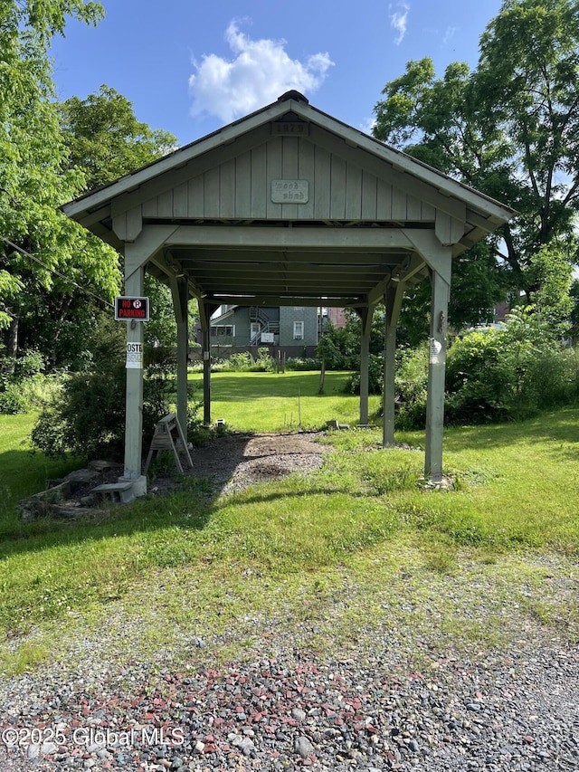 59 W St, Whitehall Village, NY 12887 - view of property's community with a detached carport and a yard