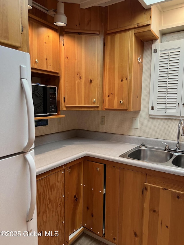 59 W St, Whitehall Village, NY 12887 - kitchen with freestanding refrigerator, black microwave, light countertops, and brown cabinetry