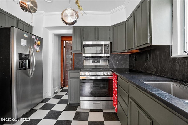 1280 Dean St, Niskayuna, NY 12309 - kitchen featuring stainless steel appliances, dark flooring, dark countertops, tasteful backsplash, and ornamental molding