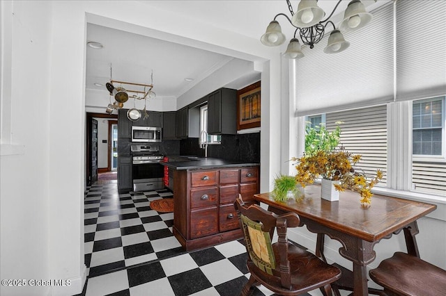 1280 Dean St, Niskayuna, NY 12309 - kitchen featuring stainless steel appliances, dark floors, a chandelier, dark countertops, and backsplash