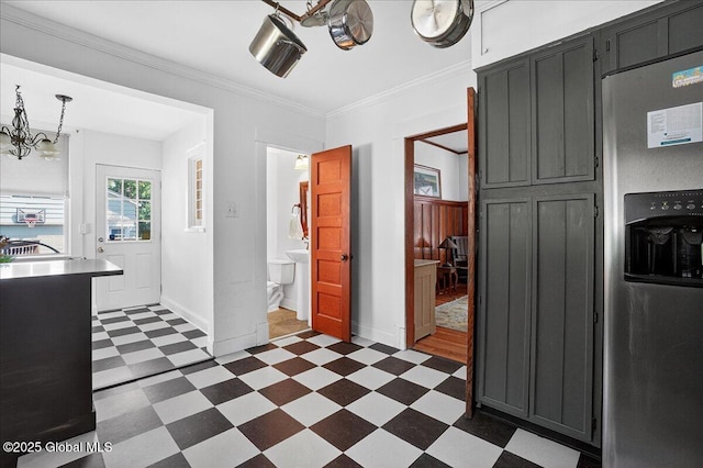 1280 Dean St, Niskayuna, NY 12309 - kitchen featuring stainless steel fridge with ice dispenser, dark flooring, a chandelier, crown molding, and dark cabinetry