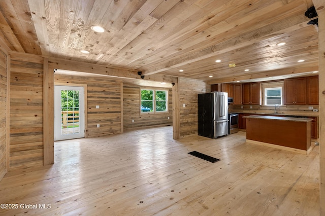 28 Gates Ave, Victory, NY 12871 - kitchen featuring appliances with stainless steel finishes, wood ceiling, open floor plan, light wood-style flooring, and healthy amount of natural light