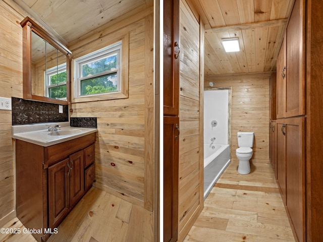 28 Gates Ave, Victory, NY 12871 - bathroom featuring wooden ceiling, wooden walls, hardwood / wood-style floors, and vanity