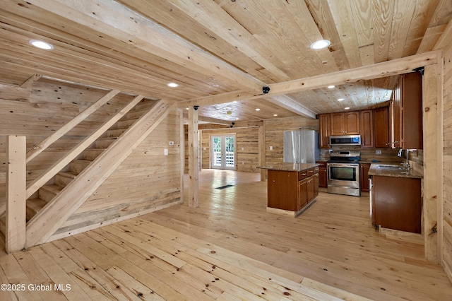 28 Gates Ave, Victory, NY 12871 - kitchen featuring stainless steel appliances, a wood ceiling with exposed beams, light wood-style floors, a kitchen island, and brown cabinetry