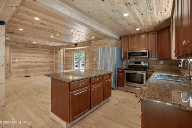 28 Gates Ave, Victory, NY 12871 - kitchen with appliances with stainless steel finishes, wooden ceiling, light wood finished floors, a center island, and dark stone counters