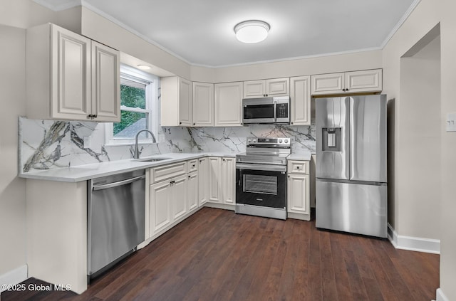 311 Old Loudon Rd, Colonie, NY 12110 - kitchen featuring appliances with stainless steel finishes, light countertops, ornamental molding, dark wood-type flooring, and white cabinetry