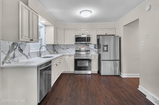 311 Old Loudon Rd, Colonie, NY 12110 - kitchen with appliances with stainless steel finishes, light countertops, dark wood-type flooring, white cabinets, and crown molding