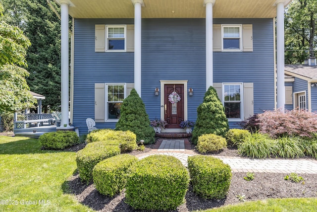 2 Eddy Ln, East Greenbush, NY 12144 - view of front of house featuring a porch and a front yard