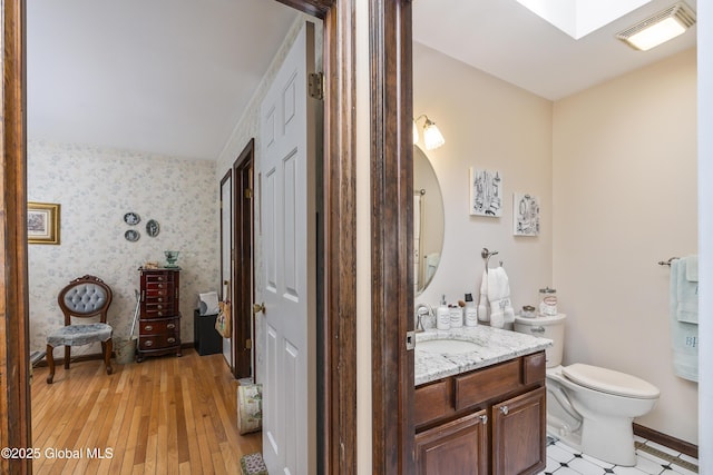 2 Eddy Ln, East Greenbush, NY 12144 - bathroom with vanity, hardwood / wood-style flooring, and wallpapered walls