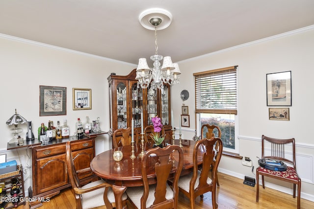 2 Eddy Ln, East Greenbush, NY 12144 - dining room featuring a chandelier, crown molding, and light wood finished floors