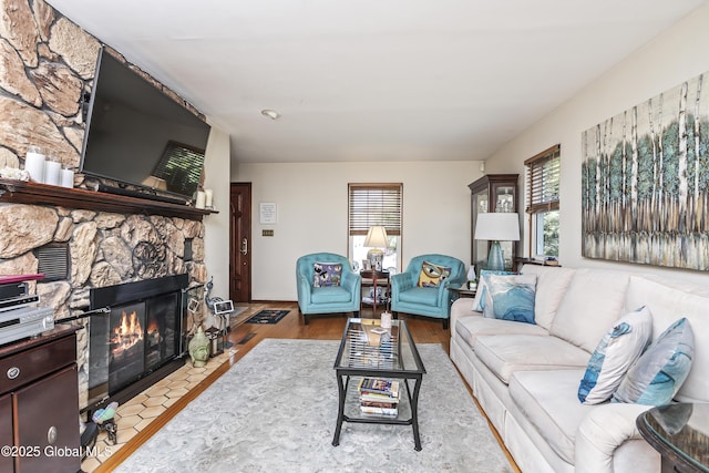 2 Eddy Ln, East Greenbush, NY 12144 - living room featuring healthy amount of natural light, a stone fireplace, and wood finished floors