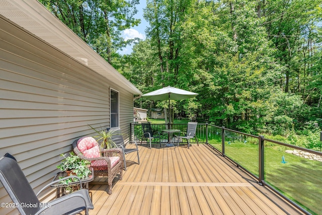 25 Mockingbird Ln, Queensbury, NY 12804 - wooden terrace featuring a lawn, view of wooded area, and outdoor dining space