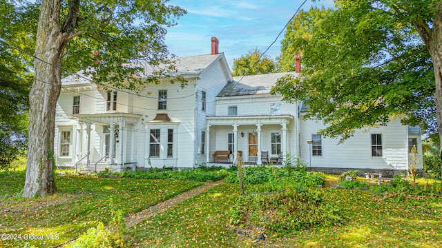 359 Wall St, Northumberland, NY 12871 - view of front of home with covered porch, a chimney, and a high end roof