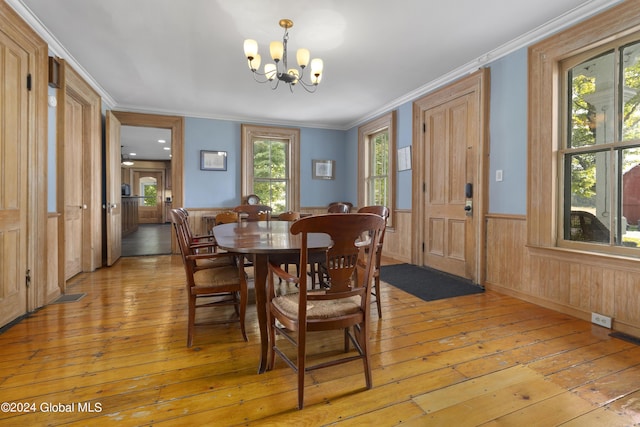 359 Wall St, Northumberland, NY 12871 - dining room with light wood-style flooring, a chandelier, a wainscoted wall, crown molding, and wood walls