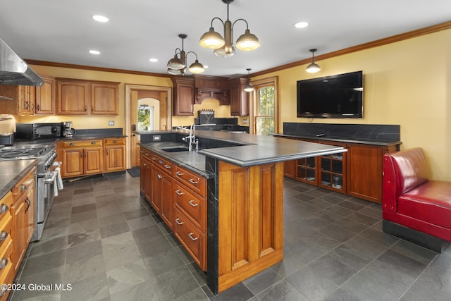 359 Wall St, Northumberland, NY 12871 - kitchen with gas range, crown molding, dark countertops, a kitchen island with sink, and brown cabinetry
