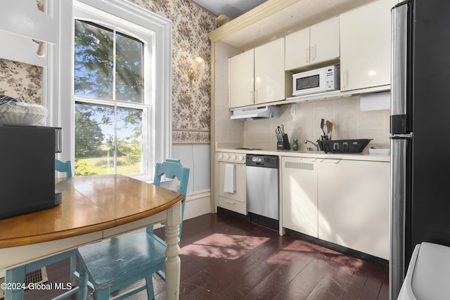 359 Wall St, Northumberland, NY 12871 - kitchen featuring appliances with stainless steel finishes, wallpapered walls, light countertops, dark wood finished floors, and white cabinetry