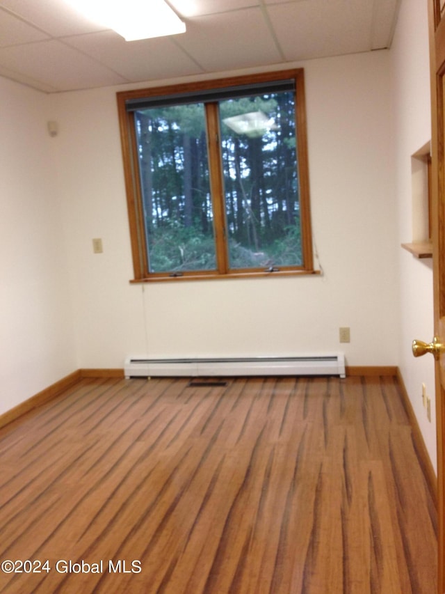 336 State Route 29, Greenwich, NY 12834 - unfurnished room featuring a baseboard heating unit and wood finished floors