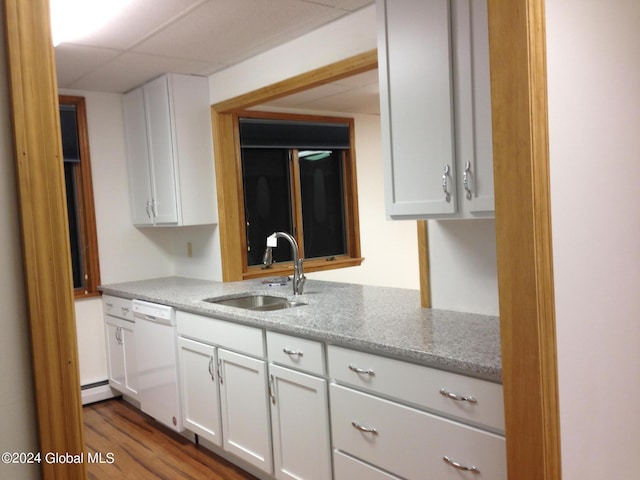 336 State Route 29, Greenwich, NY 12834 - kitchen with white dishwasher, white cabinets, light stone counters, wood finished floors, and a paneled ceiling