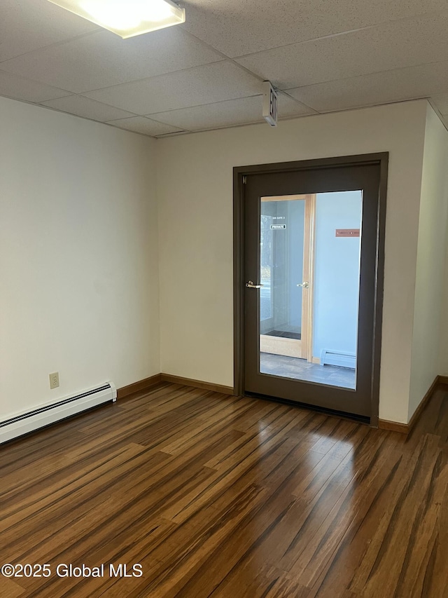 336 State Route 29, Greenwich, NY 12834 - spare room featuring a baseboard heating unit, baseboard heating, dark wood-style flooring, and a drop ceiling