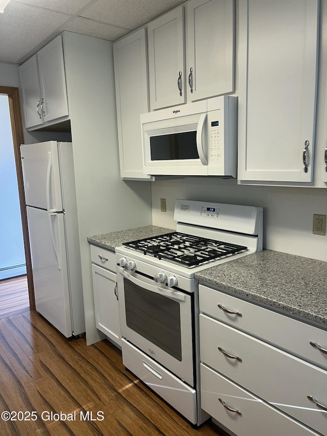 336 State Route 29, Greenwich, NY 12834 - kitchen featuring white appliances, dark wood-style floors, light stone countertops, and white cabinets
