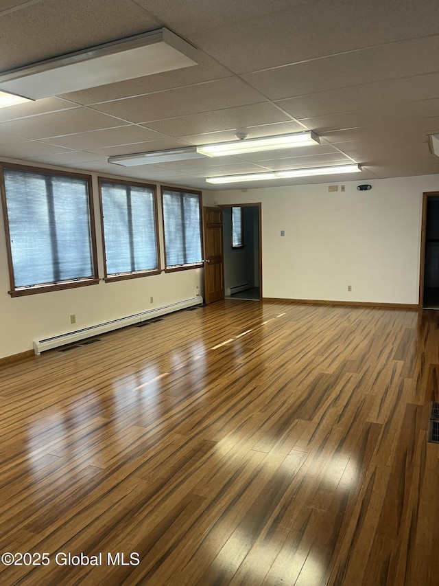 336 State Route 29, Greenwich, NY 12834 - unfurnished room with a baseboard radiator, wood finished floors, and a paneled ceiling