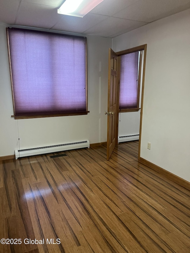 336 State Route 29, Greenwich, NY 12834 - spare room featuring a baseboard radiator, wood finished floors, and a drop ceiling