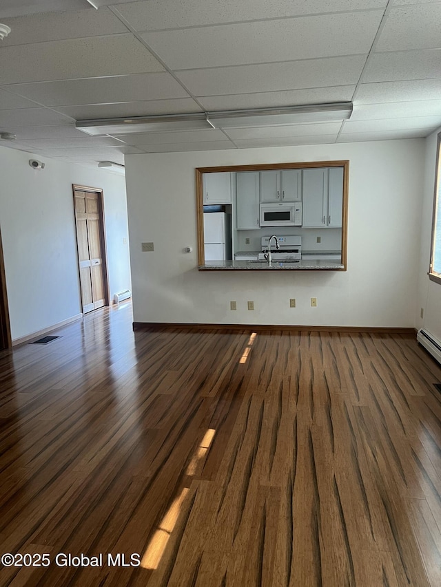 336 State Route 29, Greenwich, NY 12834 - unfurnished living room with a drop ceiling and dark wood-type flooring