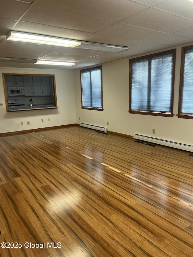 336 State Route 29, Greenwich, NY 12834 - unfurnished room with baseboard heating, dark wood-type flooring, and a paneled ceiling