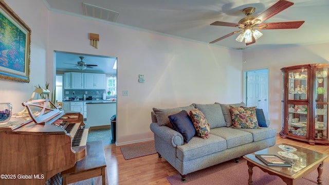 88 County Route 26a, Stuyvesant, NY 12173 - living room with a ceiling fan, light wood-type flooring, and crown molding