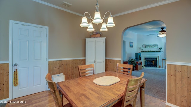 88 County Route 26a, Stuyvesant, NY 12173 - dining area featuring arched walkways, light wood-type flooring, wainscoting, a fireplace, and ornamental molding