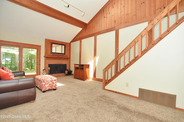 1B Scotch Mist Way, Malta, NY 12020 - living area with lofted ceiling, carpet floors, rail lighting, a large fireplace, and stairway