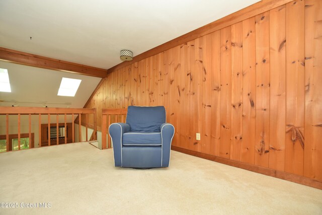 1B Scotch Mist Way, Malta, NY 12020 - living area featuring a skylight, wooden walls, carpet, and an upstairs landing