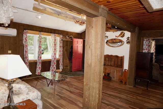 469 Military Rd, Edinburg, NY 12134 - living area with a wall mounted air conditioner, wood-type flooring, wooden walls, and lofted ceiling