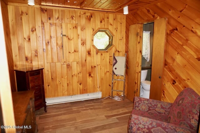 469 Military Rd, Edinburg, NY 12134 - unfurnished room with wooden ceiling, wood walls, a baseboard heating unit, and wood finished floors
