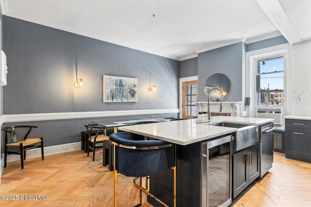 218 Lancaster St, Albany, NY 12210 - kitchen with wine cooler, dark cabinetry, a kitchen island with sink, healthy amount of natural light, and crown molding