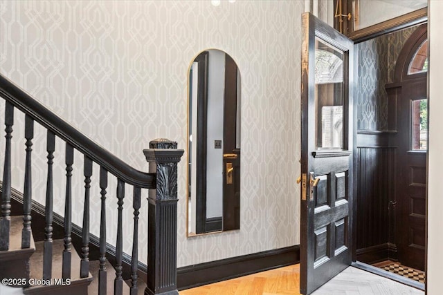 218 Lancaster St, Albany, NY 12210 - foyer with wallpapered walls, arched walkways, and stairway