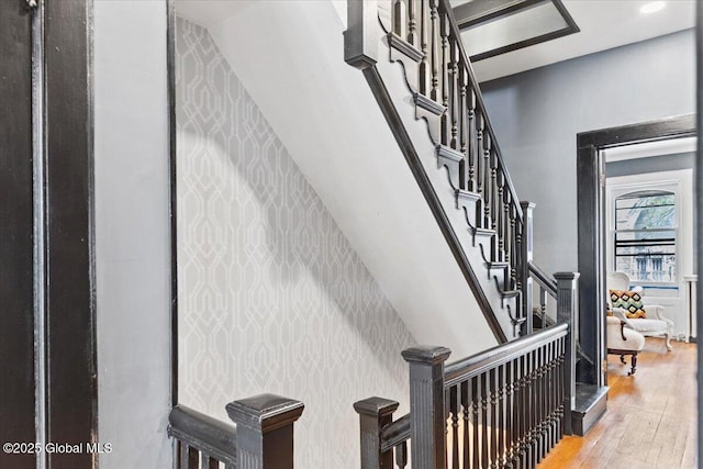 218 Lancaster St, Albany, NY 12210 - stairway with wallpapered walls, hardwood / wood-style floors, and an accent wall