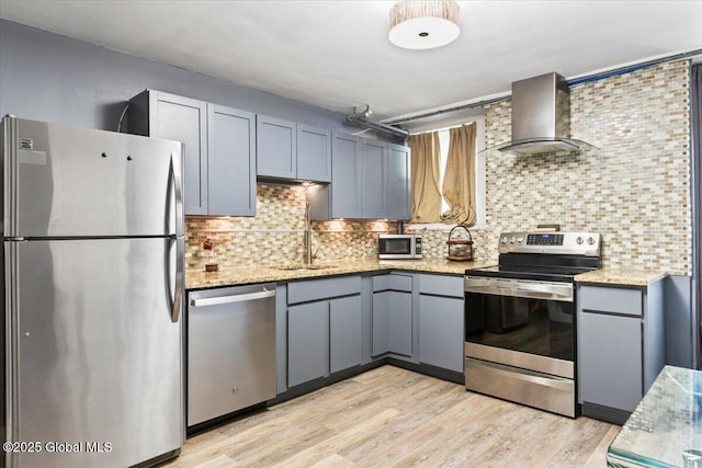 218 Lancaster St, Albany, NY 12210 - kitchen featuring stainless steel appliances, wall chimney exhaust hood, decorative backsplash, and light stone countertops