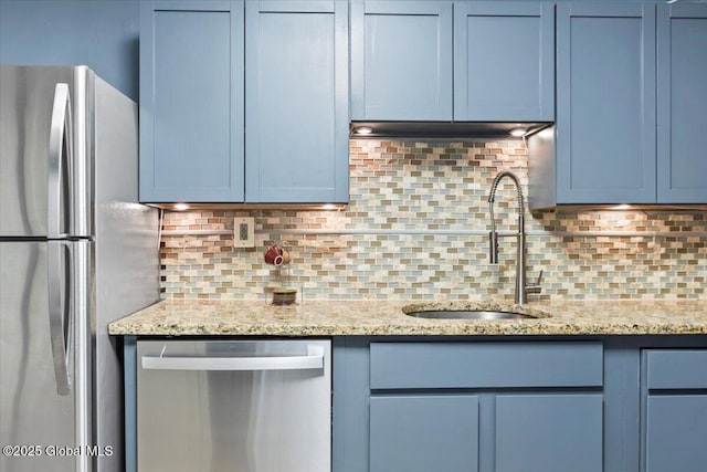 218 Lancaster St, Albany, NY 12210 - kitchen with appliances with stainless steel finishes, tasteful backsplash, light stone counters, and blue cabinetry