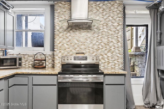 218 Lancaster St, Albany, NY 12210 - kitchen featuring appliances with stainless steel finishes, island exhaust hood, gray cabinets, and backsplash