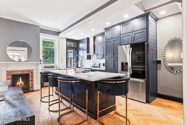 218 Lancaster St, Albany, NY 12210 - kitchen with appliances with stainless steel finishes, wall chimney range hood, light countertops, a kitchen breakfast bar, and crown molding