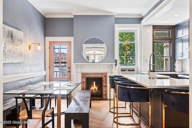 218 Lancaster St, Albany, NY 12210 - kitchen with a high end fireplace, healthy amount of natural light, a kitchen breakfast bar, ornamental molding, and light wood finished floors