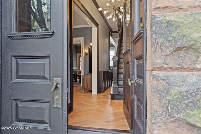 218 Lancaster St, Albany, NY 12210 - foyer with ornamental molding and a chandelier