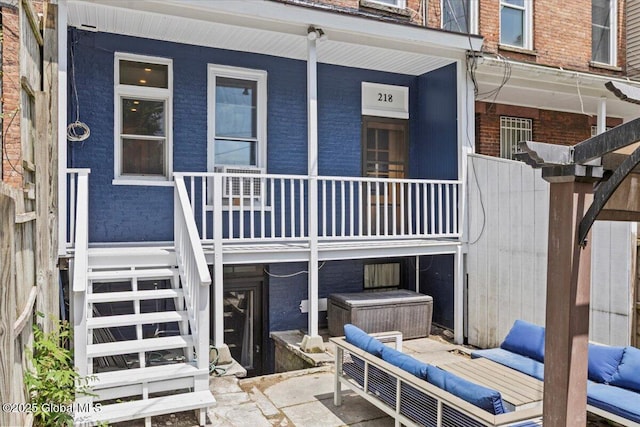 218 Lancaster St, Albany, NY 12210 - back of house featuring brick siding, outdoor lounge area, covered porch, and stairs