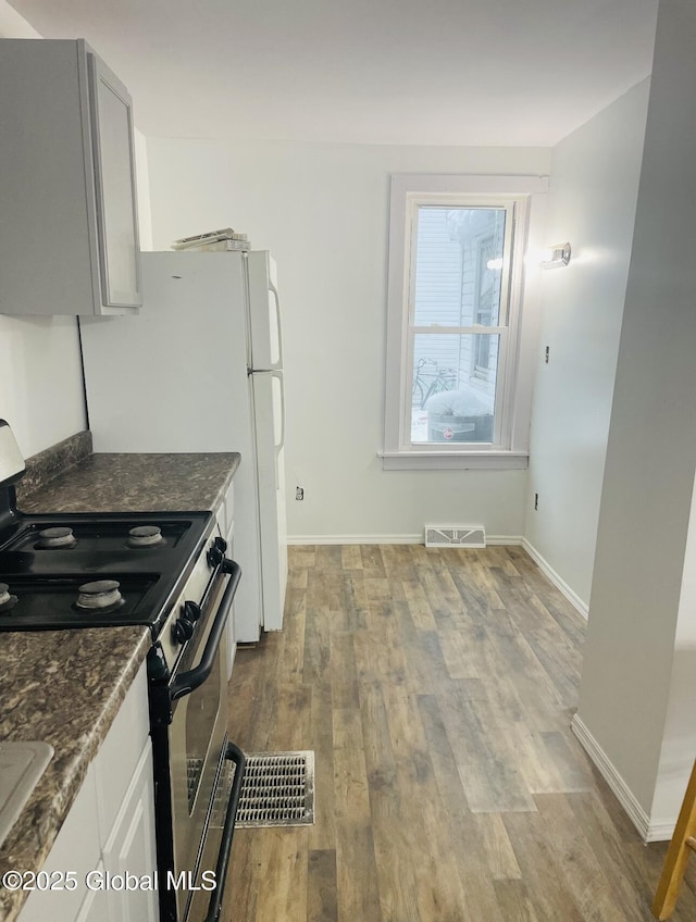 918-922 Bridge St, Schenectady, NY 12303 - kitchen with stainless steel range with electric stovetop, wood finished floors, and dark stone counters