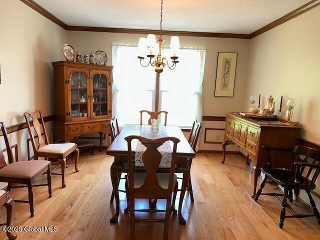12 Bain Dr, Bethlehem, NY 12054 - dining space featuring ornamental molding, light wood finished floors, and a chandelier